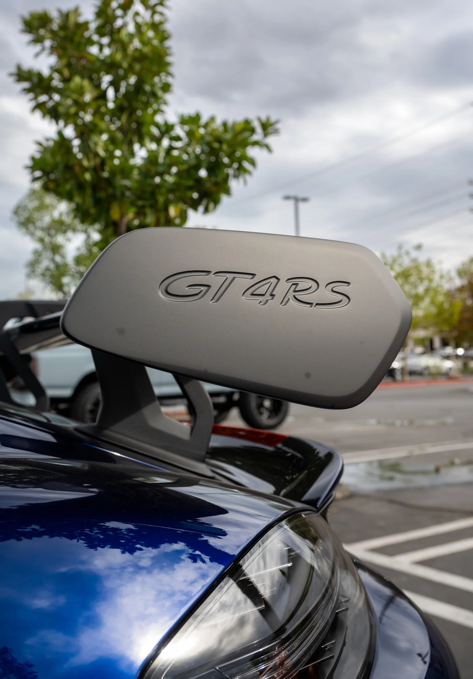 Porsche Cayman rear wing endplate with GT4RS lettering.
