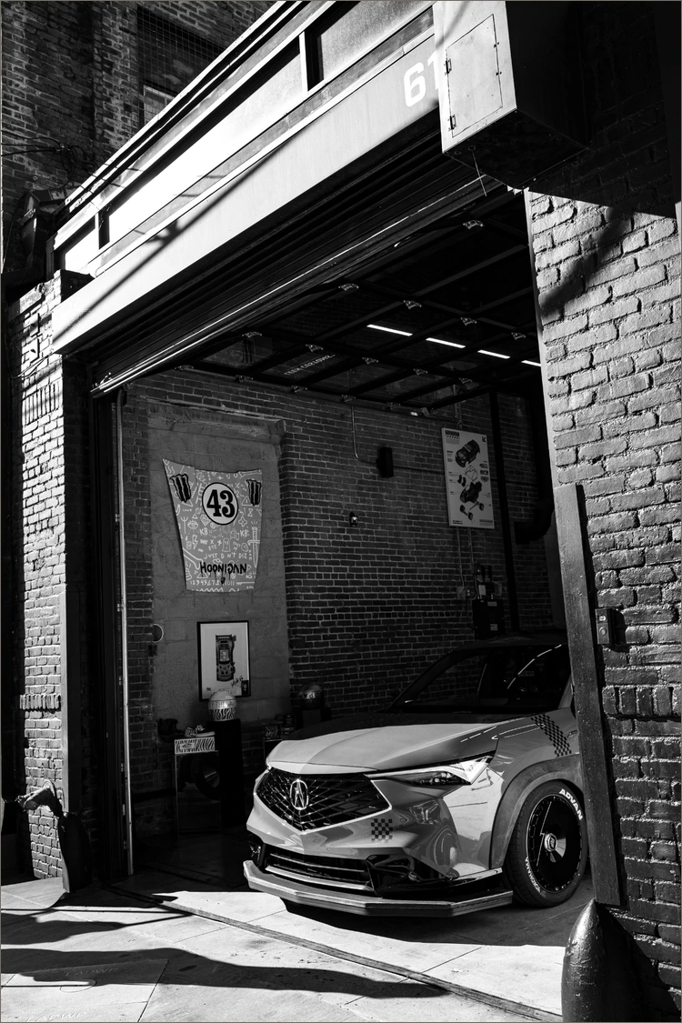The garage entrance and Acura inside in the original first-frame monochrome photograph